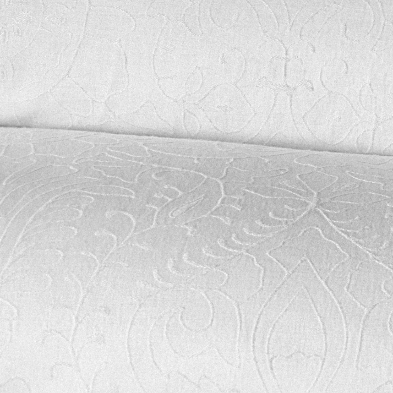 Close-up image of the Amina Ecru Duvet Set by John Robshaw, showcasing a white fabric with an intricate, embossed floral pattern, crafted from the finest quality cotton linen.