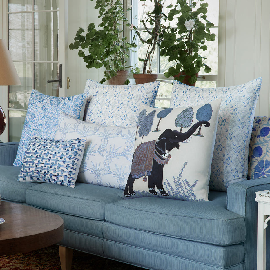 A hand-painted Indigo Elephant Decorative Pillow made of cotton linen in a living room by John Robshaw.