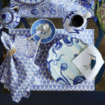 An John Robshaw navy blue and white table setting with printed plates, cups, and utensils featuring Navya Azure Napkins (Set of 4). - 30405316313134