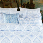 A bed with a blue and white Bhoomi Bolster made from white cotton linen. - 30400047906862