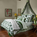 A green and white bedroom with a John Robshaw French Knot Dark Sage Throw. - 30395700969518