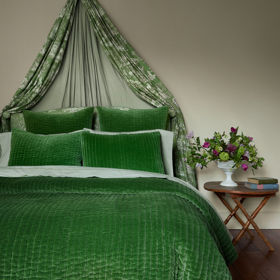 A John Robshaw Velvet Moss Quilt bed with a velvet canopy.