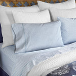 A bed with Hunir Lapis Organic Sheets from John Robshaw bedding and hand embroidered pillows. - 30395673903150