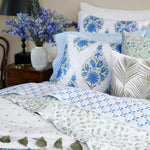 A bed with beautiful Mayra Azure Quilt-patterned blue and white bedding, featuring hand quilted cotton voile pillows, by John Robshaw. - 30395680849966