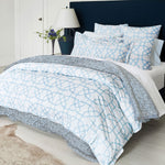 A bed with an Alisha Light Indigo Organic Duvet from Duvets & Shams and a rug. - 30544641785902