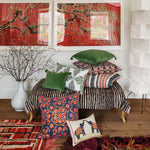 A John Robshaw hand-quilted Velvet Moss Kidney Pillow, created by Indian artisans, lies gracefully on the floor. - 30484739457070