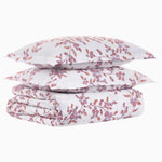 A stack of Oha Lavender Organic Duvets by John Robshaw with a long staple cotton percale fabric and a floral pattern on them. - 30769085120558