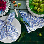 A set of Juri Indigo Placemats (Set of 4) by John Robshaw on a green table. - 30800055402542