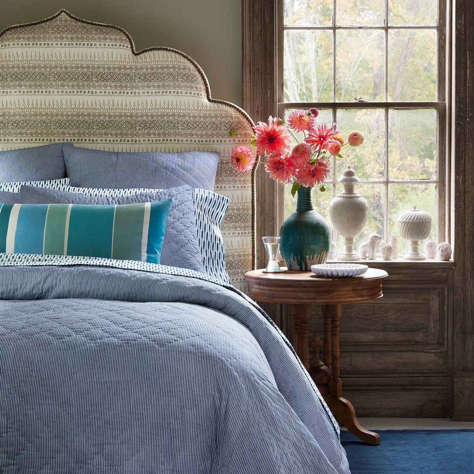 A blue and white bedroom with Nandi Indigo Quilt pillows by John Robshaw.