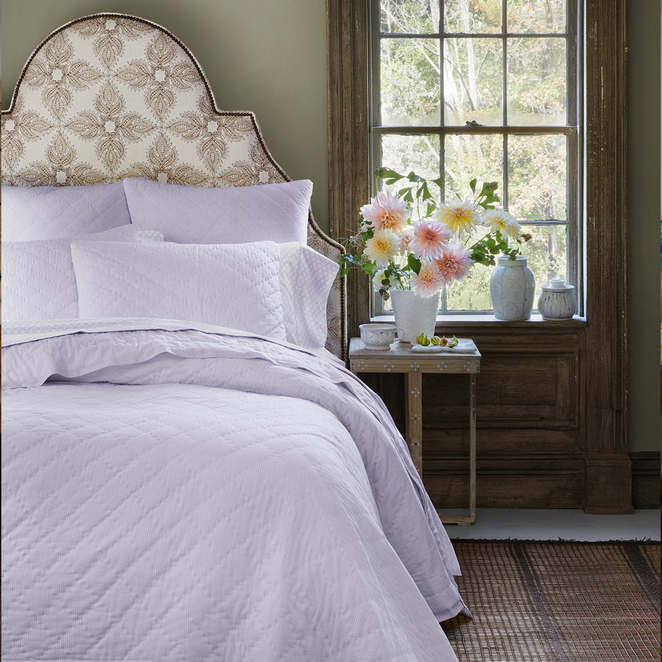 A Nandi Lavender Quilted bed with John Robshaw lavender pillows.