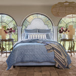A Nandi Indigo Quilt bed in a bedroom with arched windows, featuring simple stripes. (Brand: John Robshaw) - 30783828459566