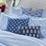 John Robshaw Fulki decorative pillows with indigo edging on a bed. - 30801450729518