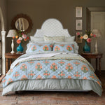 A John Robshaw Cinde Sage Organic Duvet with a blue and orange floral comforter. - 30784322535470