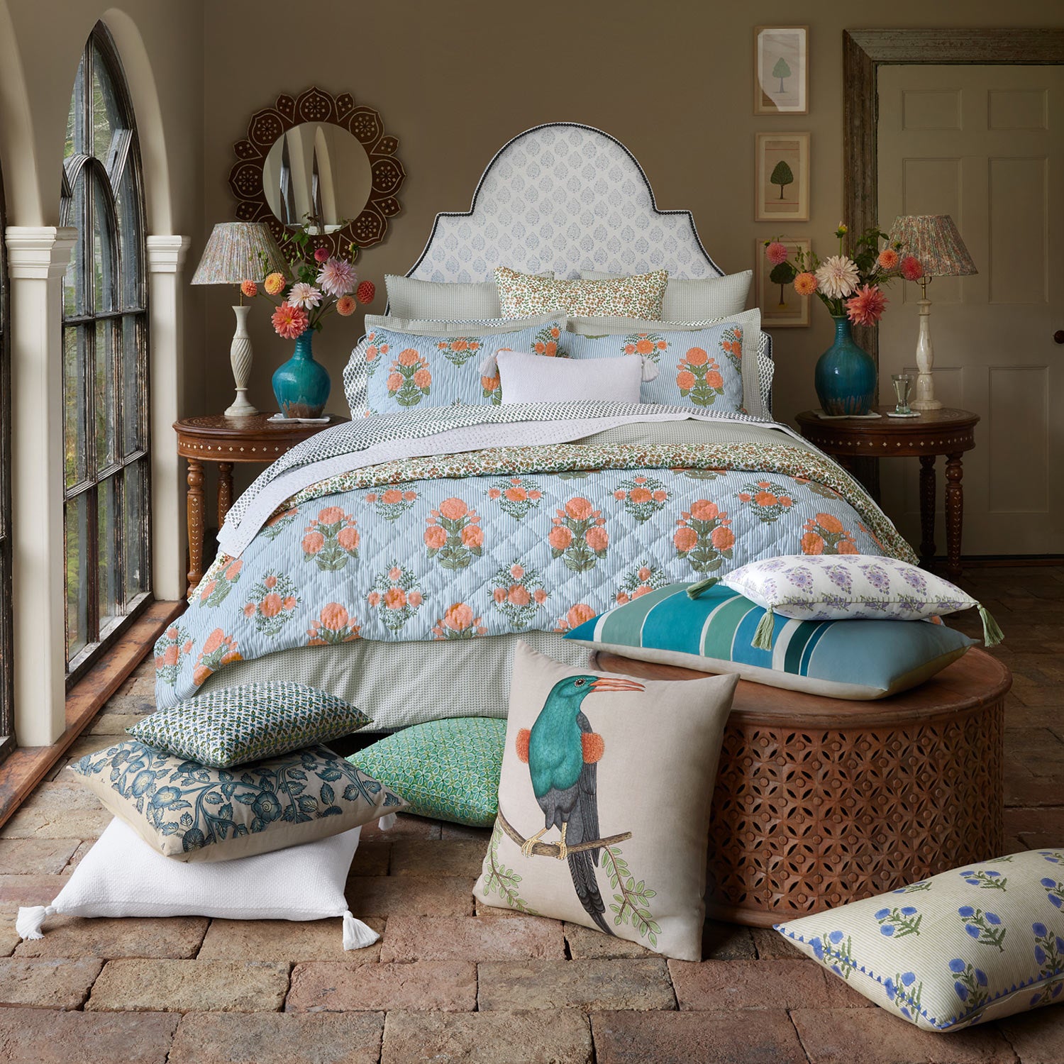 A bed with 200 thread count pillows and a John Robshaw Cinde Sage Organic Duvet.
