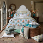 A bed adorned with Bimal Decorative Pillows by John Robshaw, featuring exquisite French knots and a beautiful block print design. - 30801455972398