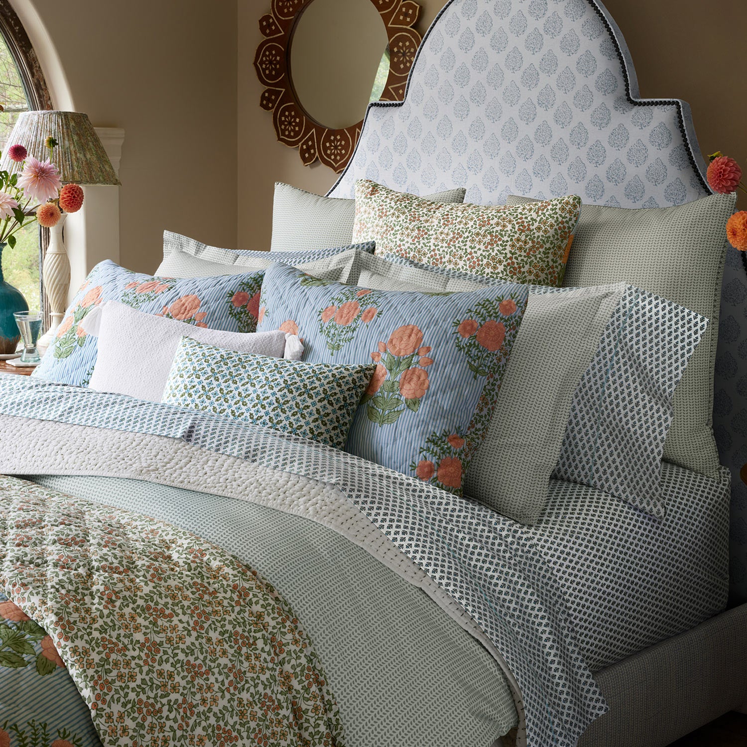 A bed with Cala Sage Organic Sheets by John Robshaw.