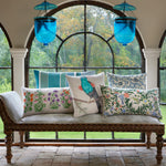 A John Robshaw Ekatan Bolster with pillows and blue lanterns in front of an arched window, exuding modern elegance. - 30801467801646