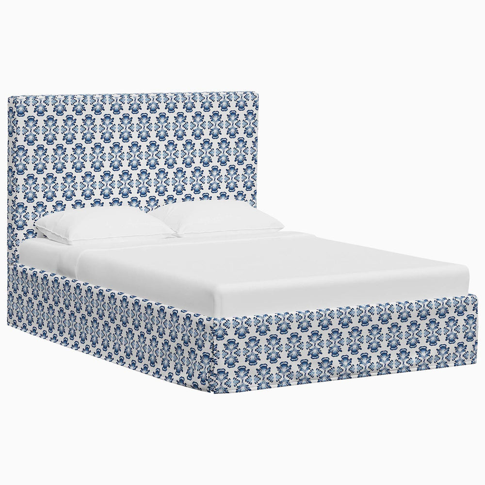 A John Robshaw Shona print bed with a blue and white damask pattern.