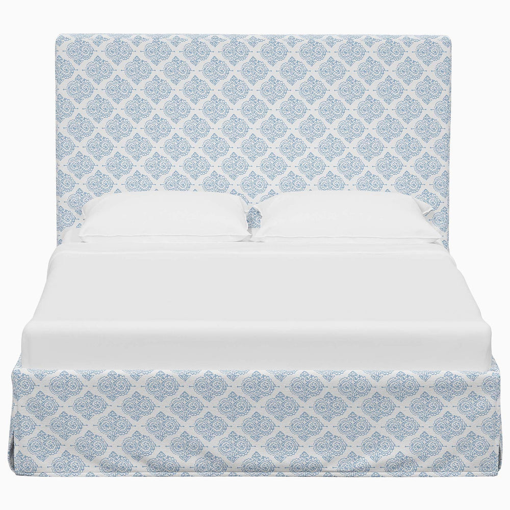 A Shona Bed from John Robshaw with a blue and white patterned cover made from fabrics.