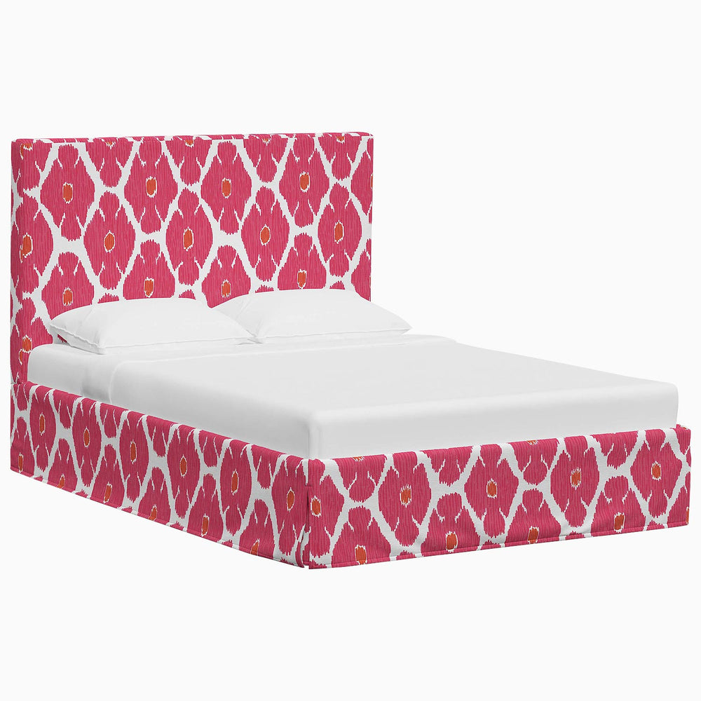 A Shona Bed by John Robshaw with a pink and white patterned headboard, featuring vibrant prints and textiles.