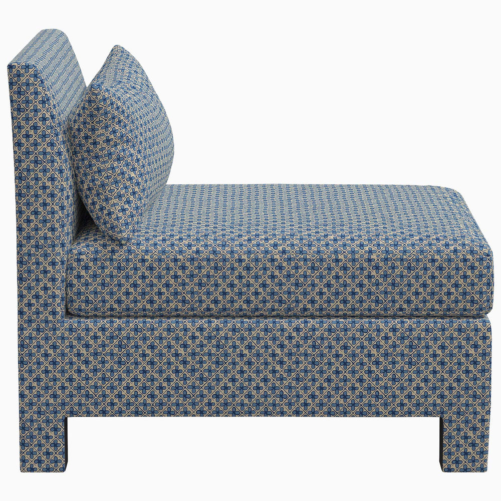 The John Robshaw Sameera Armless Chair, upholstered in an exclusive blue fabric with a cushion, offers a custom seating arrangement option.
