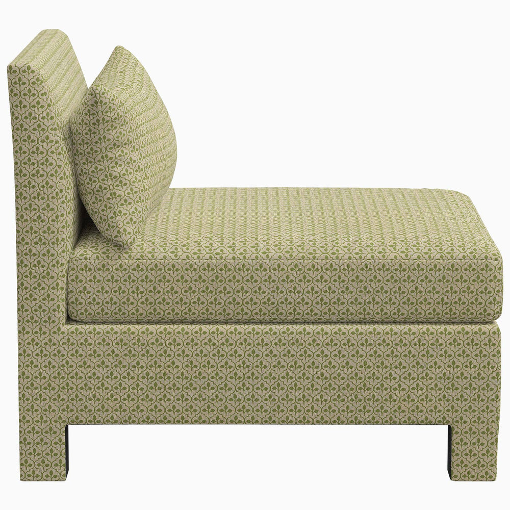 The John Robshaw Sameera Armless Chair is a green upholstered chair with a cushion, offering custom seating arrangements and exclusive fabrics.