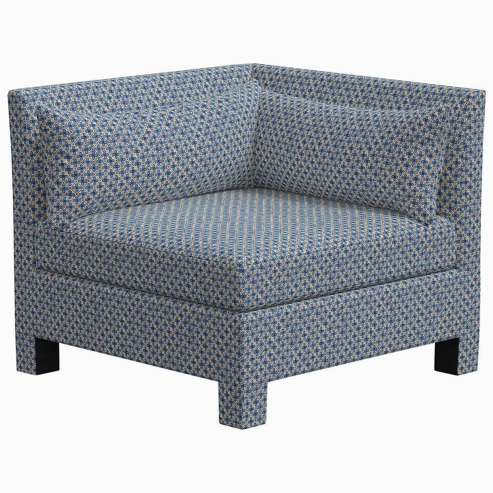 The John Robshaw Sameera Armless Chair is a stylish and comfortable seating option. This exclusive chair features a blue color and is adorned with a polka dot pattern, adding a fun touch to any space.