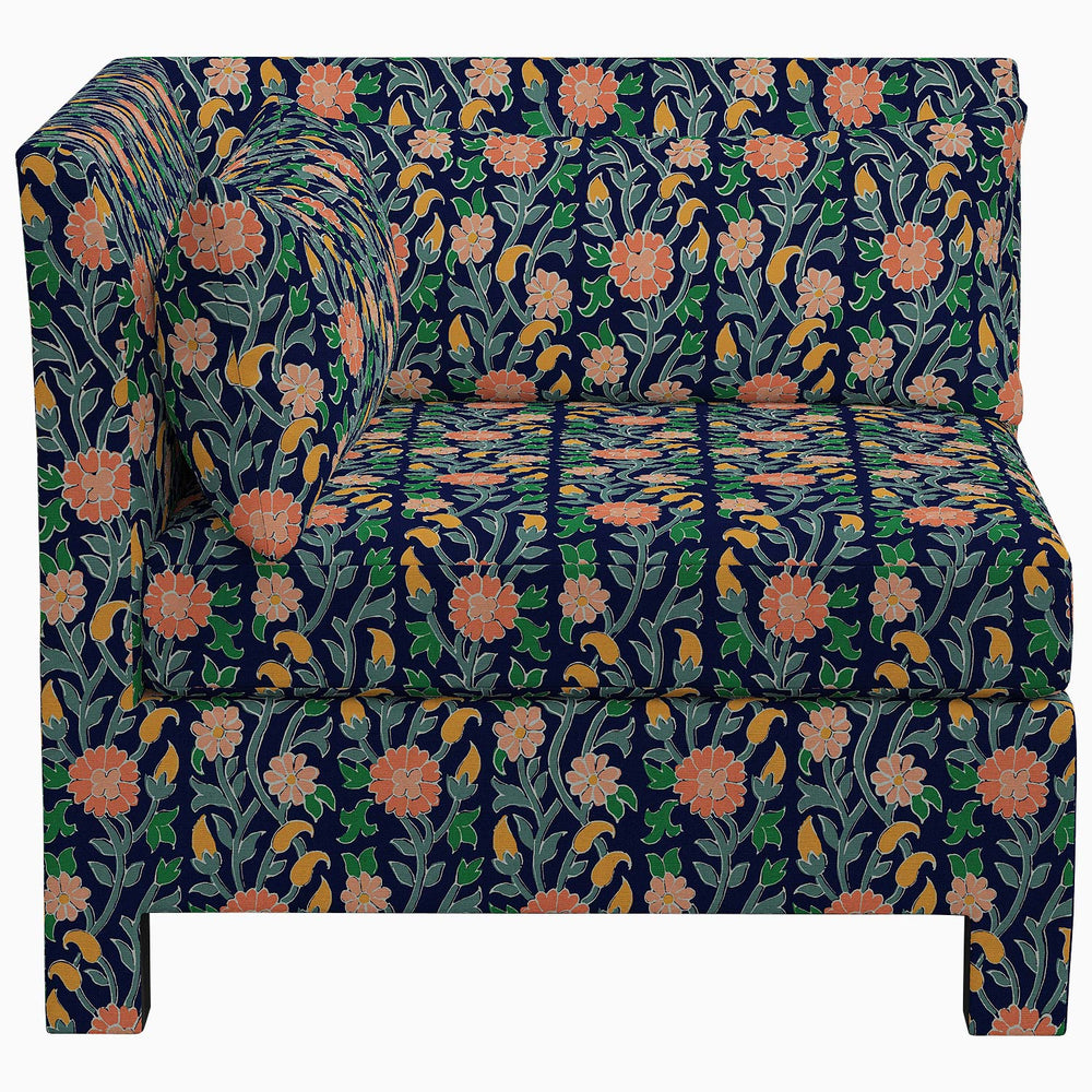 The John Robshaw Sameera Corner Chair, featuring exclusive fabrics, showcases a stunning floral pattern to elevate your custom seating arrangement.