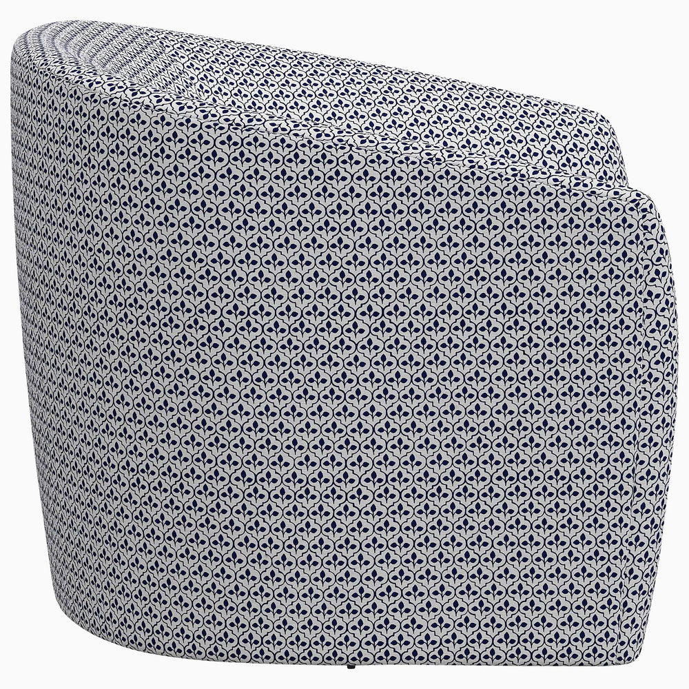 A John Robshaw Amrit Swivel chair with a blue and white print.