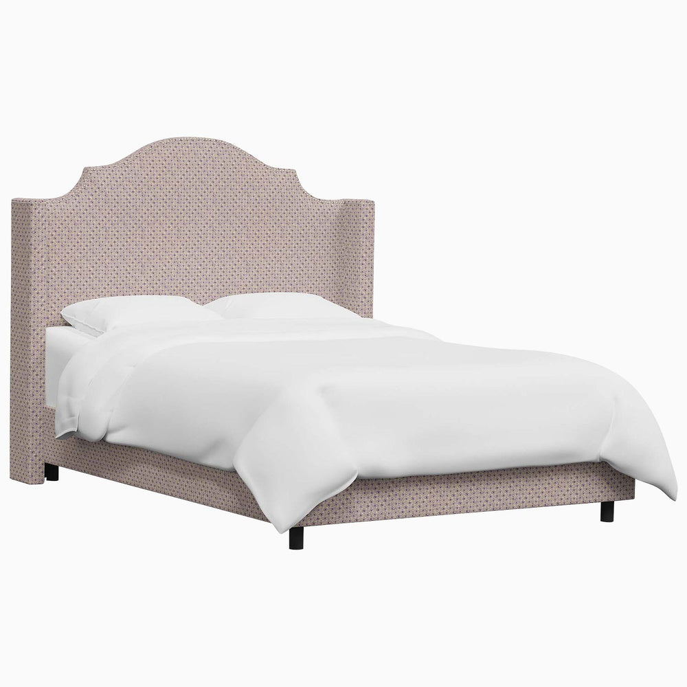 The John Robshaw Samrina bed features a white bed frame complemented by a pink headboard with Mughal arches, thoroughly crafted by John Robshaw.