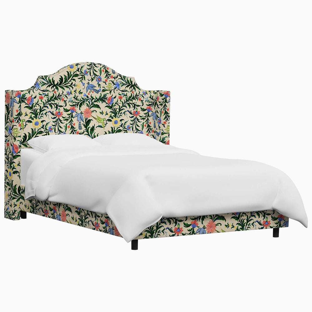The John Robshaw Samrina bed features a floral upholstered headboard, showcasing intricate Mughal arches inspired by the designs of John Robshaw.