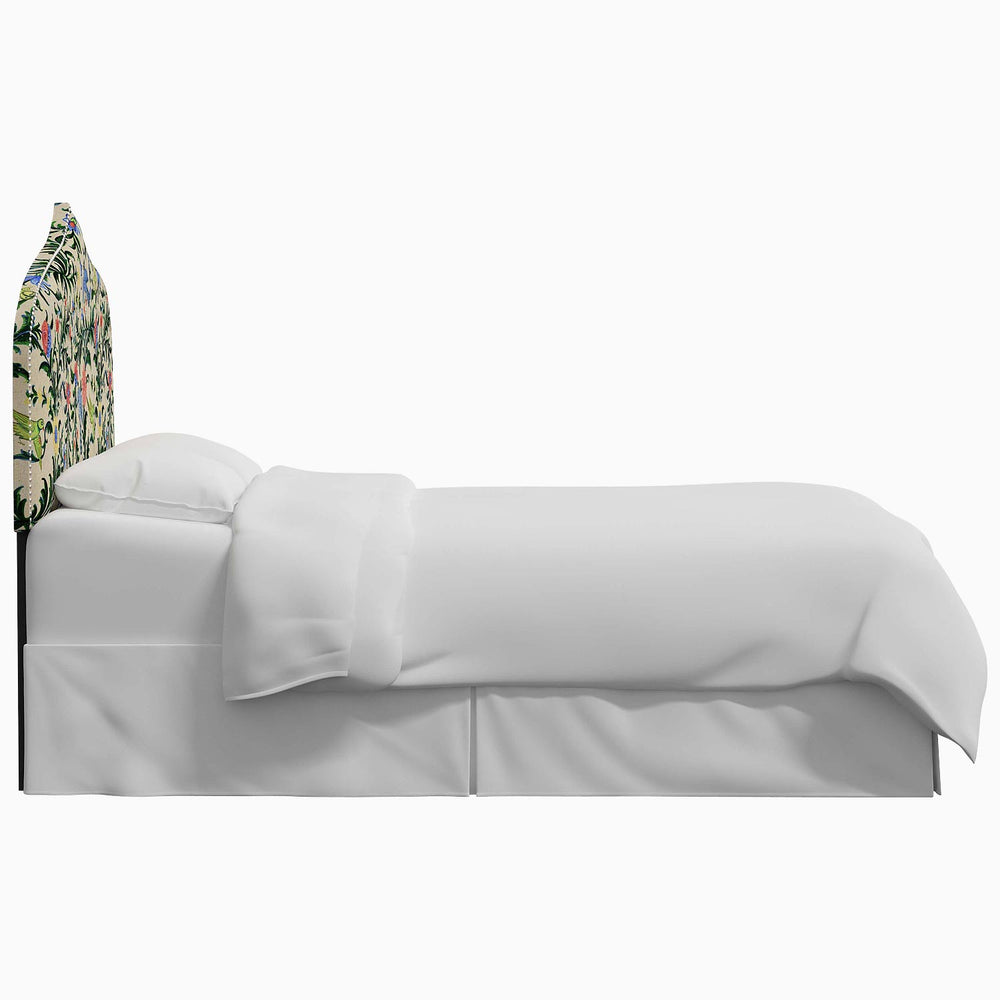 A white bed with a floral Alina Headboard featuring John Robshaw prints.