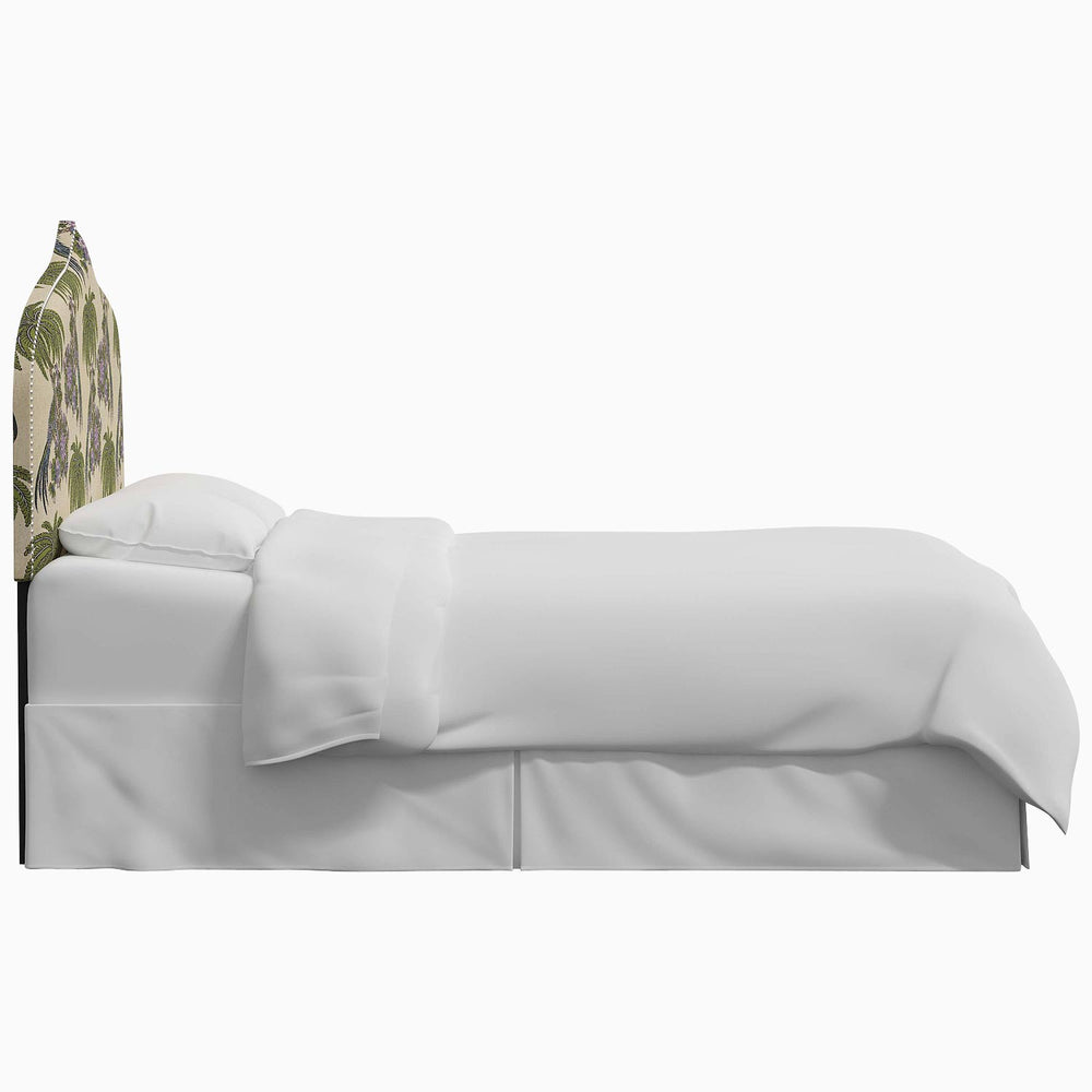 An image of a bed with a white sheet and a camouflage headboard featuring the John Robshaw Alina Headboard design.