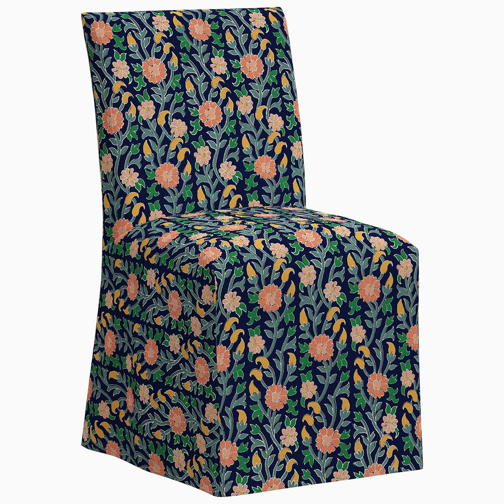 The John Robshaw Sadia Slipcover Chair is a stylish dining chair featuring a floral pattern on the back.