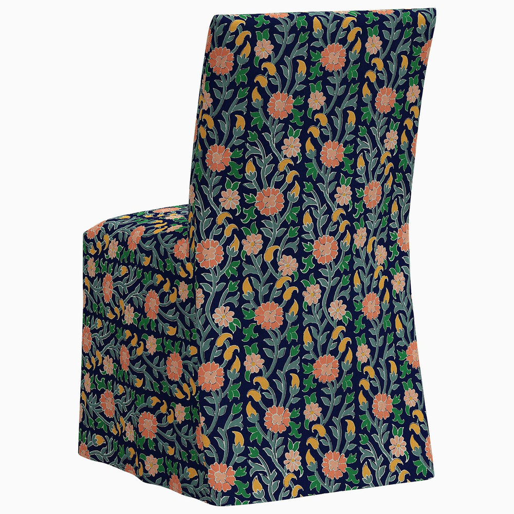 The John Robshaw Sadia Slipcover Chair is a stylish dining chair featuring a beautiful floral pattern on its back.