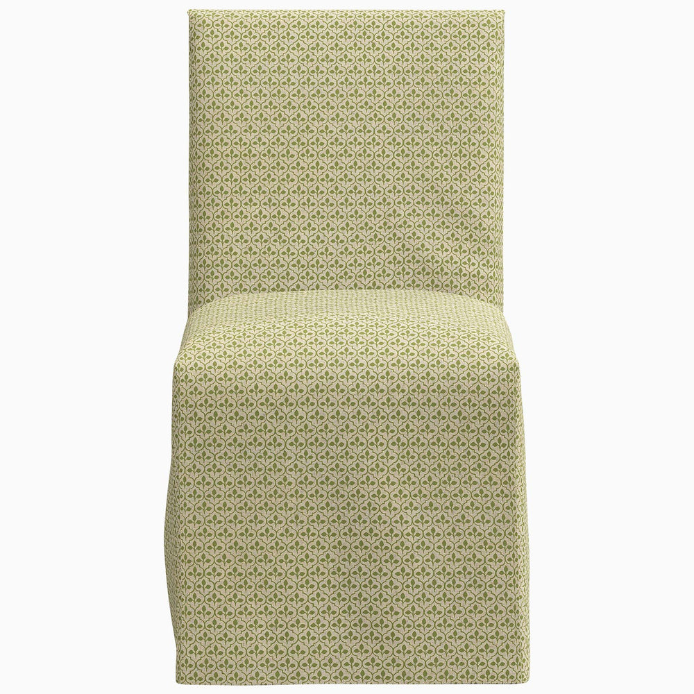 The John Robshaw Sadia Slipcover Chair is a green patterned chair with a white background, perfect as a dining chair.