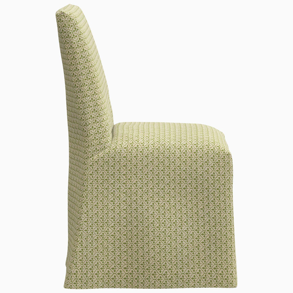 The John Robshaw Sadia Slipcover Chair is a stylish dining chair featuring a green patterned fabric.