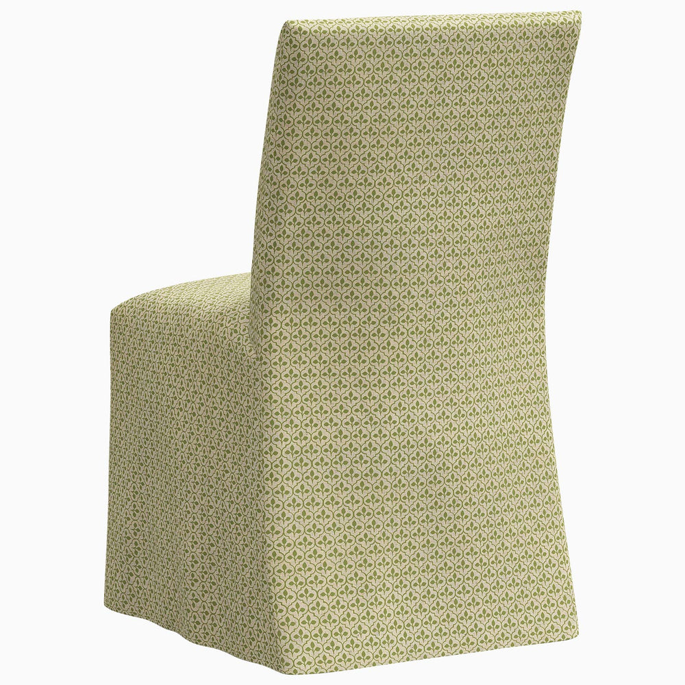 The John Robshaw Sadia Slipcover Chair is a stylish dining chair featuring a beautiful green patterned fabric.