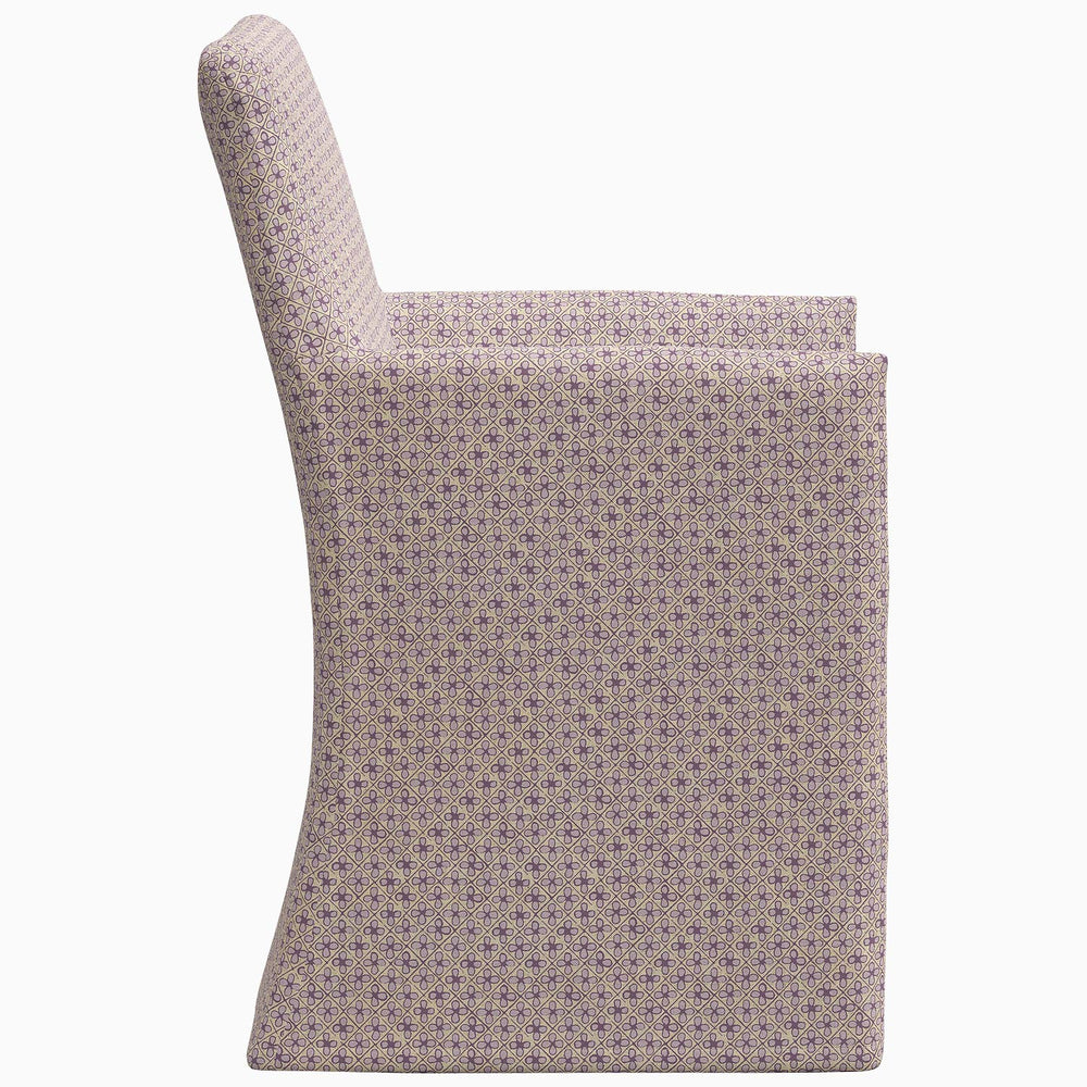 The back of a Rekha Slipcover Dining Chair adorned with an exclusive purple polka dot pattern, made by John Robshaw.