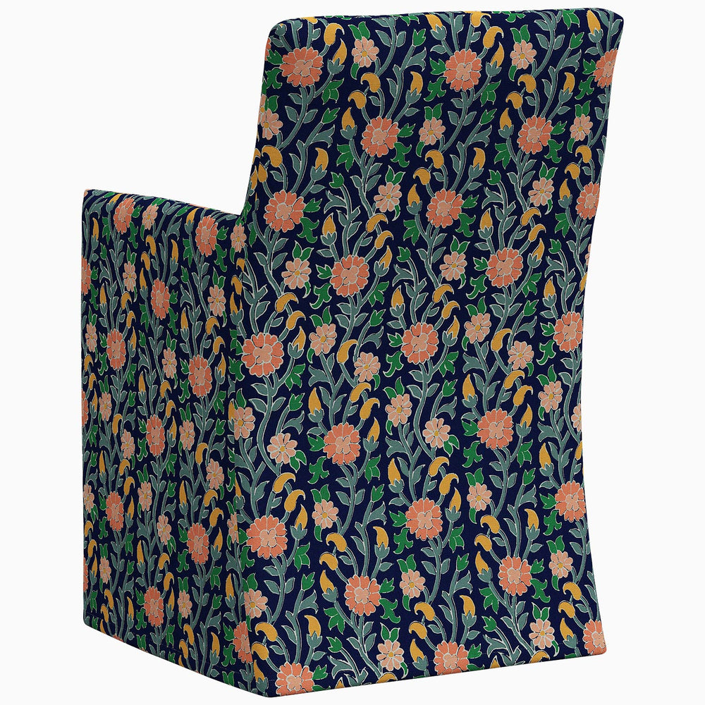 An exclusive John Robshaw Rekha Slipcover Dining Chair with a floral pattern on the back.