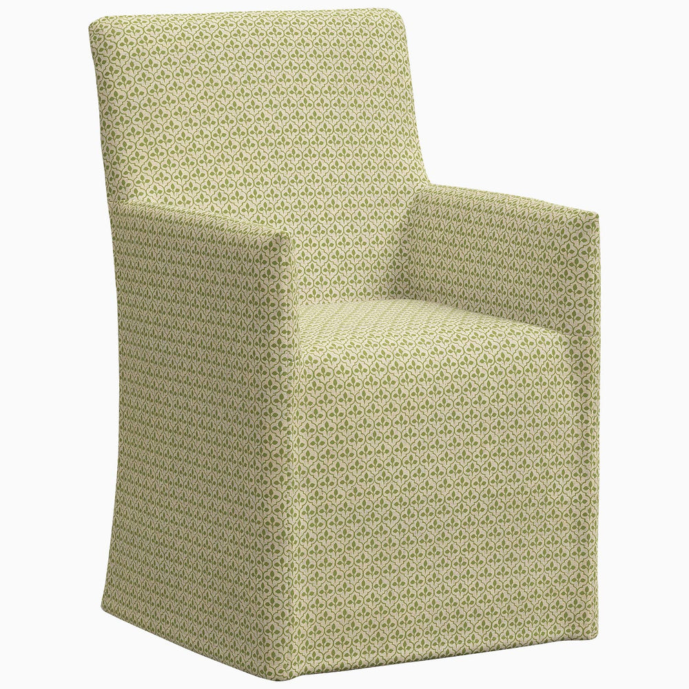 An exclusive Rekha Slipcover Dining Chair upholstered chair with a green pattern by John Robshaw.
