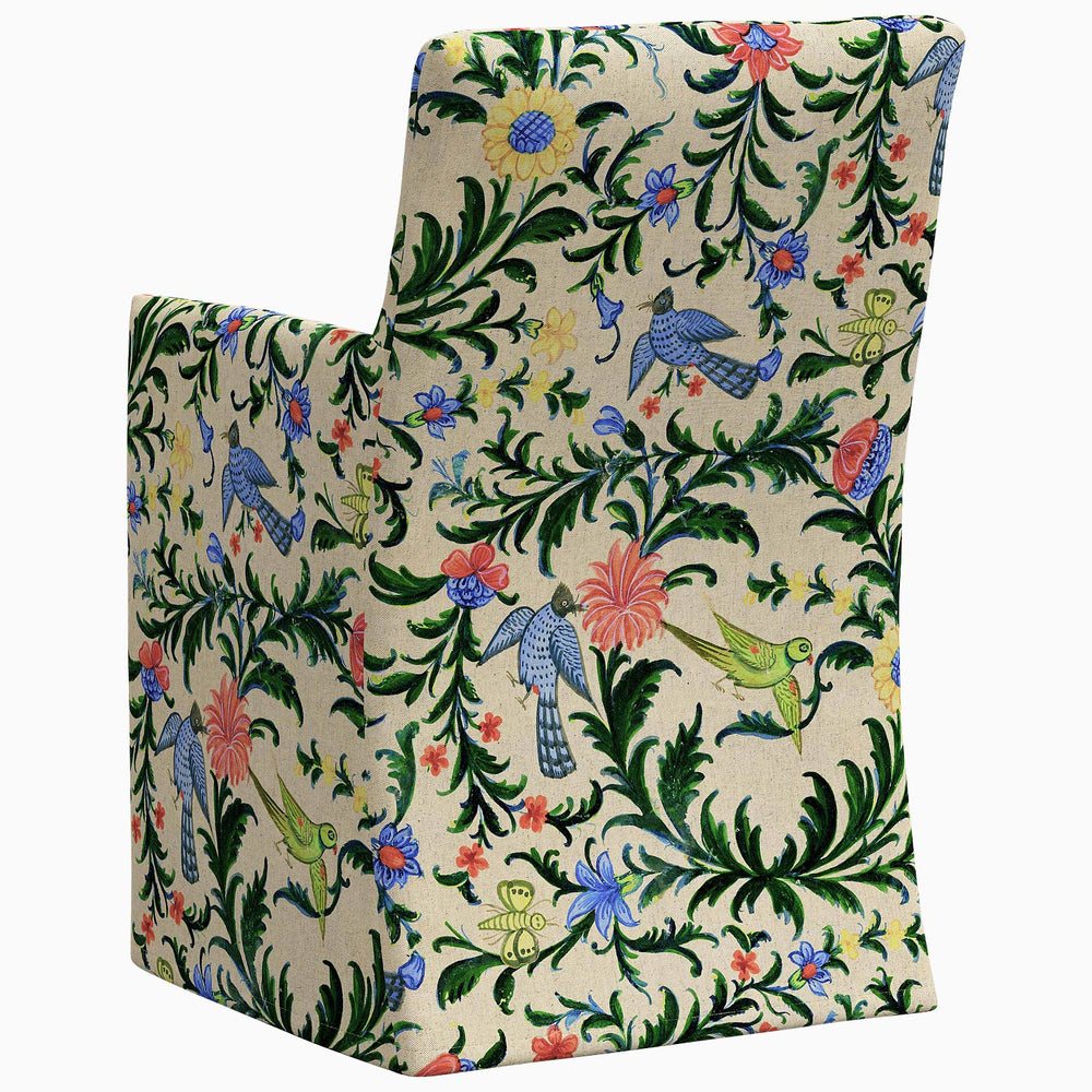 The John Robshaw Rekha Slipcover Dining Chair features an exclusive print of floral pattern swatches, adding a touch of elegance and style to any space.