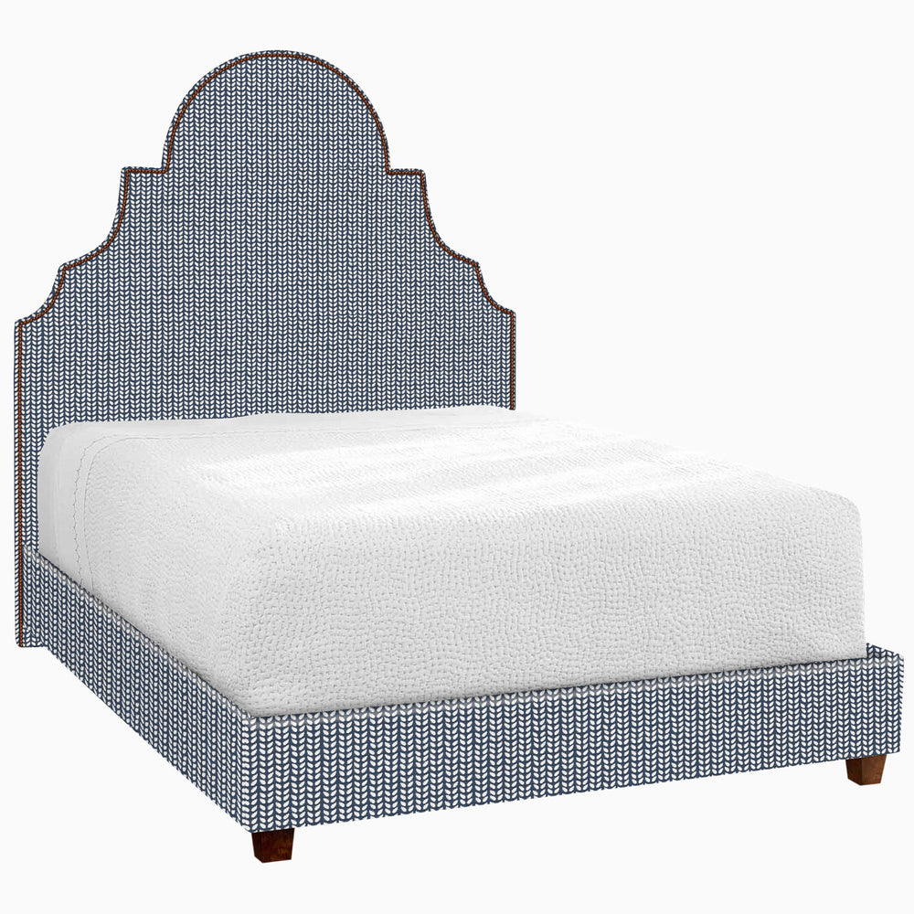 A Custom Dara Bed upholstered in blue with a white glove delivery option for shipping by John Robshaw.