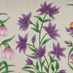 A John Robshaw Garden Party Bolster, a hand-painted cotton fabric with purple and orange flowers, perfect for a garden party. - 30801479237678