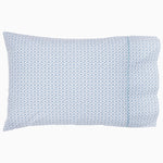 A blue and white Hunir Lapis Organic Sheets pillow with a geometric pattern made from organic cotton by Sheets & Cases. - 30395662893102