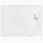 A white Stitched Silver Placemat with a silver ring on it, featuring a formal style and hand-stitched cotton slub by Tabletop. - 30405335711790