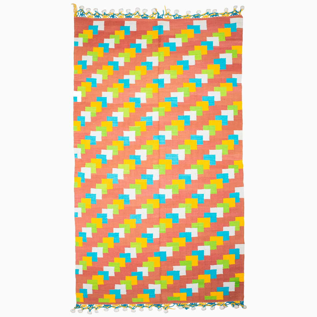 A vibrant beach towel featuring a stylish pattern of triangles, reminiscent of vintage rugs from Punjab's weaving centers, the Left to Right Then Back Again Rug by John Robshaw.
