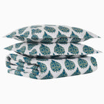 A stack of Bilva Peacock Organic Duvets made with organic long staple cotton and a blue and white paisley pattern from John Robshaw. - 30765665615918