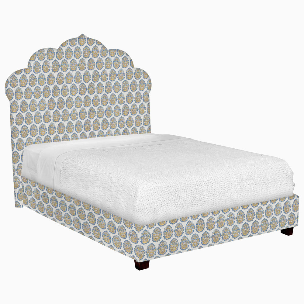 A John Robshaw Custom Bihar Bed with a blue and white patterned fabric headboard.