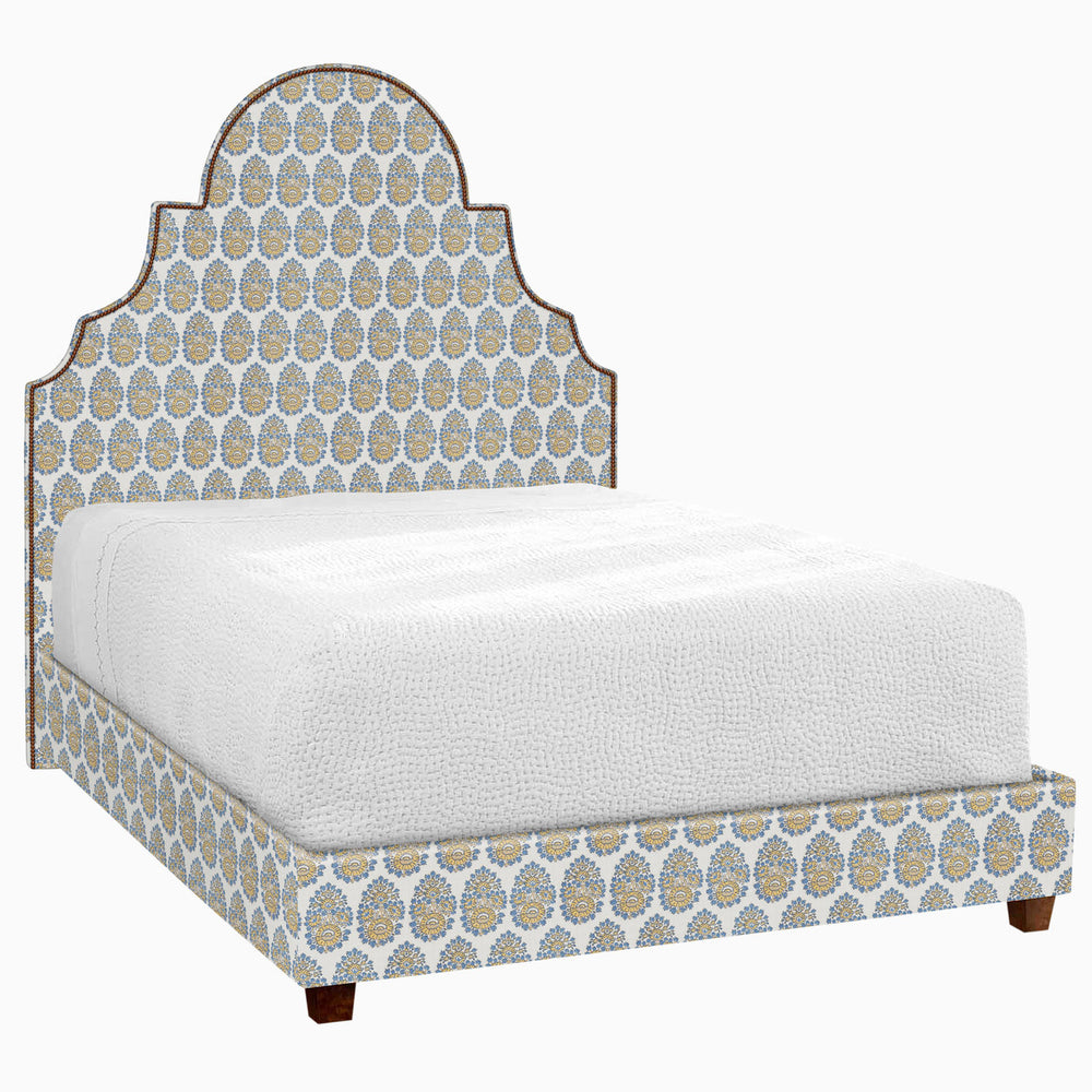 A Custom Dara Bed with a blue and white patterned headboard available for white glove delivery by John Robshaw.